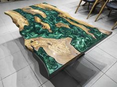 a table made out of wood with green and gold paint on it's surface