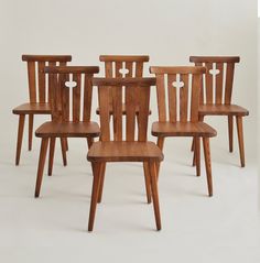 six wooden chairs sitting next to each other