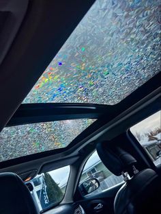 the inside of a car with lots of colored bubbles on the windshield and dash board