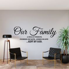 two chairs in front of a wall with the words our family on it and a potted plant