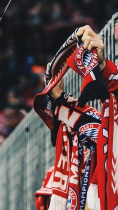 a close up of a person wearing a red and white scarf