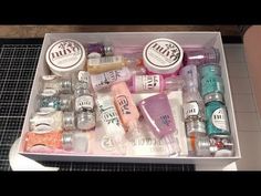 a box filled with lots of different types of nail polish