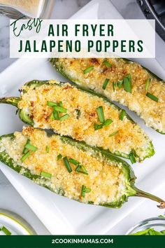 two green peppers with parmesan cheese on top and the words easy air fryer jalapeno poppers