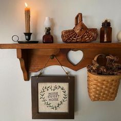 a shelf with some items on it and a basket hanging from the wall next to it