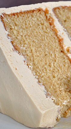 a slice of cake with white frosting on a plate