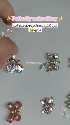 someone is holding several different types of brooches