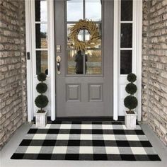 the front door is decorated with black and white checkered rugs