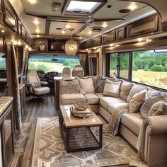 a living room with couches, tables and chairs in the middle of an rv