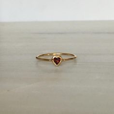 This Garnet Heart Ring brings love with you wherever you go. Show someone you love that you always have them in your heart. A great gift ring! Details: 14k gold (available in yellow, rose or white gold)Garnet heart measures about 3mm Free Shipping on Domestic Orders Materials: Garnet, 14k gold Need your ring bigger tha 14k Gold Heart-shaped Ruby Promise Ring, Heart-shaped 14k Gold Ruby Promise Ring, 14k Gold Heart-shaped Ruby Ring For Promise, 14k Gold Red Heart Ring For Promise, Red 14k Gold Heart Ring For Promise, Red 14k Gold Heart Promise Ring, Vintage Heart Ring, Red Heart Ring, Garnet Heart