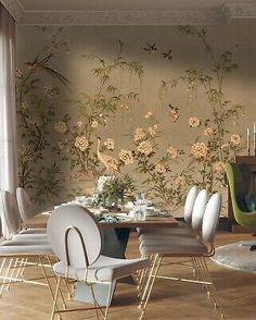 a dining room table with chairs around it and wallpaper on the walls behind it