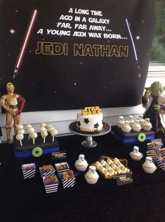 star wars themed dessert table with cake and cupcakes