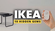 a hand holding a mouse next to a table with the words ikea on it