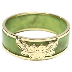 14 Karat Yellow Gold Green Jade Two-Part Ring. Two rings in one, a beautiful light sage green jade band and a yellow gold two band ring with a a four petal flower and leaves at the center. The ring measure 7mm wide and 2.4mm thick. The ring is size 8. The rings together weigh 4.06 grams. Luxury Green Engraved Men's Ring, Green Jade Jewelry, Gold And Jade Ring, Jade Engagement Ring Green, Jade Gold Ring, Jade Wedding Ring, Jade Engagement Ring, Four Petal Flower, Green Wedding Rings