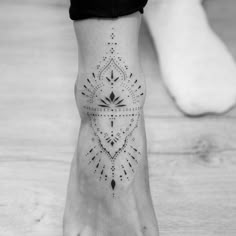 a woman's foot with a tattoo on it