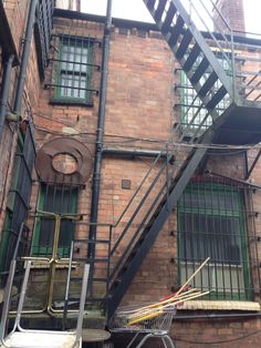 an old brick building with stairs leading up to the second floor