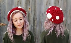 a woman with pink hair wearing a red and white crocheted mushroom beanie