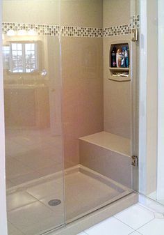 a walk in shower sitting inside of a bathroom