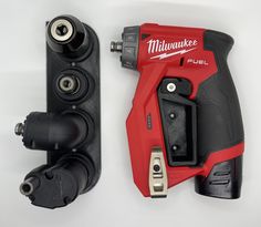 a red and black cordless drill is next to a tool holder