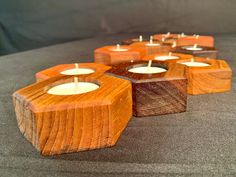 wooden candles are lined up on the floor