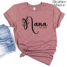 Looking for the perfect gift for your beloved Nana or Nanna? Look no further! This custom boho floral Nana shirt is a wonderful choice for a Mother's Day gift, pregnancy reveal, or just because. Show your Nana how much you care with this beautifully designed Nana tshirt. Crafted with love, this Nana to be gift is sure to put a smile on her face. Embrace the special bond you share with your Nana with this unique and thoughtful Nanna shirt. Make her day even more special with this personalized Nan Nana T Shirts, Nana Shirts, Nana Gifts, Pregnancy Reveal, Pregnancy Reveals, Boho Floral, Shirts With Sayings, Baby Bag, Small Designs