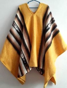 Soft and Warm shades of tan, brown and ivory exalt the fertile Andean earth. Working in luxurious alpaca. The warm but lightweight garment is woven on the hand loom.Unique Peruvian Alpaca Wool Men's Poncho Alpaca wool forms intricate geometric patterns in natural colors. Size: 56"  (145 cm )L   x  35" (80 cm)  W Traditional Brown Poncho For Festival, Hippie Brown Poncho For Winter, Bohemian Beige Poncho Cape, Hippie Brown Poncho For Festivals, Brown Alpaca Cape Poncho, Brown Alpaca Poncho Cape, Bohemian Brown Poncho For Festivals, Brown Bohemian Poncho For Festivals, Bohemian Brown Cape Shawl