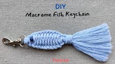 a blue keychain with a tassel hanging from it's end and the words diy macrame fish keychain