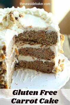 there is a cake with white frosting and walnuts on the top it has one slice cut out