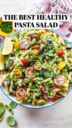 a bowl filled with pasta salad and garnished with olives