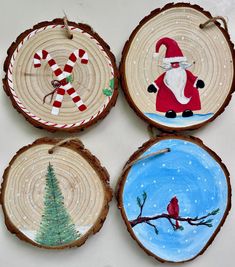 four wood slices decorated with christmas decorations