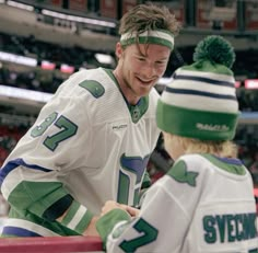 two hockey players standing next to each other