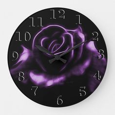 a black and purple clock with a rose on it