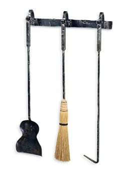 an old fashioned broom is hanging from a metal rack with two hooks on each side