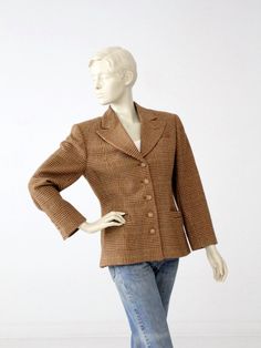 "Equestrian chic! This is a 1980s vintage Ralph Lauren tweed blazer. The fitted jacket features pockets on the waist, button detailed cuffs, and a split lapel. Five buttons close the jacket. It is lined. * ILGWU label CONDITION In fair/good condition with wear consistent with age and use. There is a small moth hole on the front near the top button. MARKED SIZE: 4 MEASUREMENTS Bust: 38\" Length: 25\" Shoulders: 17\" Outer Sleeve: 22.25\" 31376 HOW WE MEASURE → Jacket measured lying flat. → Bust m Brown Double-breasted Tweed Office Jacket, Office Brown Double-breasted Tweed Jacket, Brown Tweed Jacket With Notch Lapel And Double Button, Vintage Double Button Winter Blazer, Vintage Winter Blazer With Double Button Closure, Brown Tweed Blazer For Work, Brown Houndstooth Sport Coat For Work, Brown Tweed Jacket With Button Closure For Office, Chic Brown Tweed Blazer