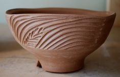 a brown bowl sitting on top of a table