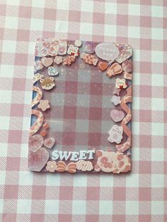 a pink and white checkered table cloth with a photo frame that says sweet on it