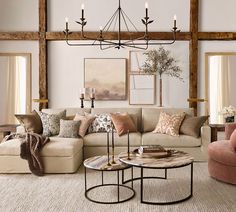 a living room filled with lots of furniture next to a wall mounted painting on the wall