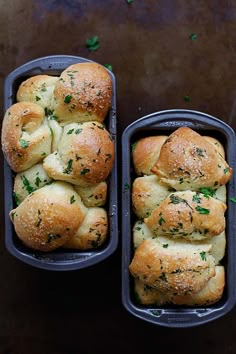 two trays filled with rolls covered in cheese and herbs