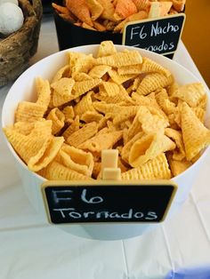 two bowls filled with cheetos sitting on top of a table