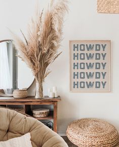 a living room filled with furniture and a large mirror on the wall next to a plant