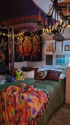 a room with a bed, lights and pictures on the wall above it is decorated in bright colors