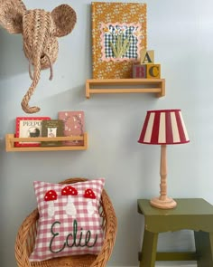 two wooden shelves with books on them and a lamp in the corner next to it