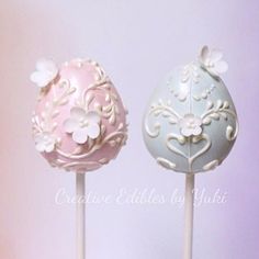 two decorated cake pops sitting on top of each other