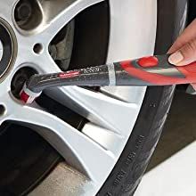 a person using a wrench to change the spokes on a car's tire