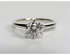 a round brilliant cut diamond engagement ring on a white background with the center stone visible