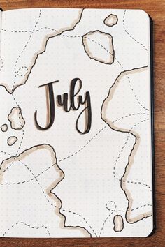 a notebook with the word july written in cursive writing on top of it