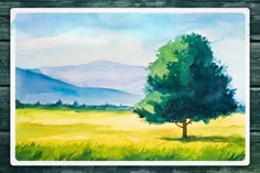 a watercolor painting of a tree in the middle of a field with mountains in the background