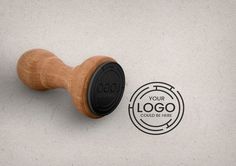 a close up of a wooden handle on a white surface with a stamp that says your logo could be here