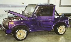 a purple pick up truck parked in a garage