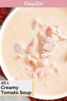 creamy tomato soup in a white bowl on a red tablecloth with text overlay