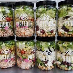 several jars filled with different types of salads